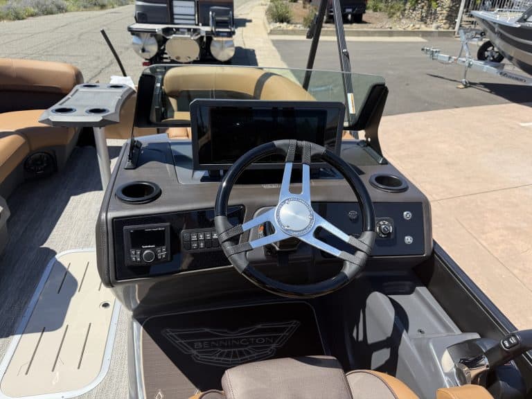 Boat dashboard with steering wheel and electronic controls for Bennington M 23 250HP.