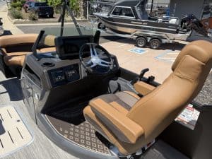 Bennington M 23 pontoon boat cockpit with steering wheel and captain's seat.