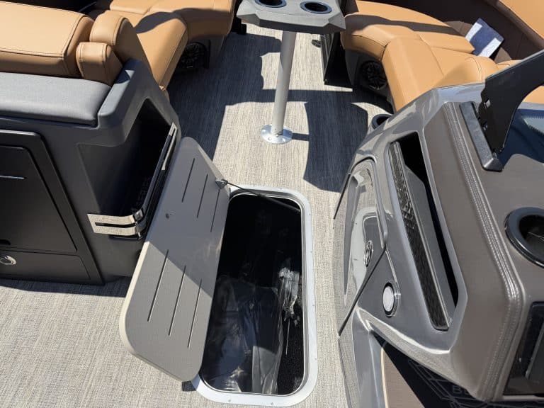 View of boat interior with seating and storage compartments in Bennington M 23.