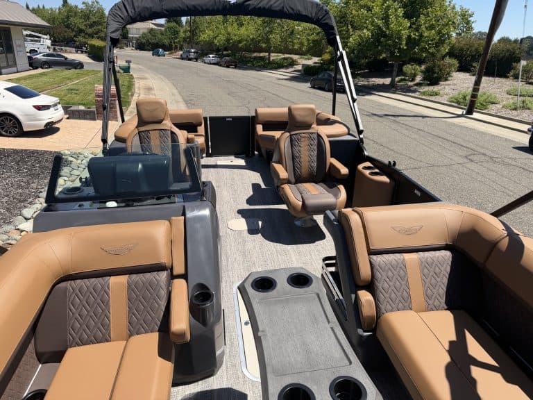 Luxury Bennington M 23 pontoon boat with tan seating and spacious layout.