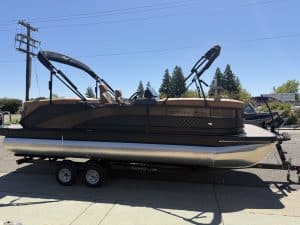Bennington M 23 pontoon boat with 250HP outboard motor on trailer.