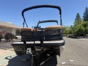 Bennington M 23 pontoon boat with 250HP outboard engine on a sunny day.
