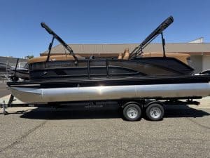 Bennington M 23 pontoon boat with dual outboard motors on trailer.