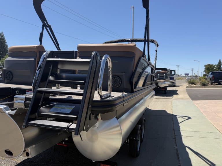 Bennington M 23 pontoon boat with 250HP outboard engine on display.