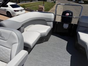 Recreational boat seating with comfortable white cushions and outboard motor, ideal for leisure and.