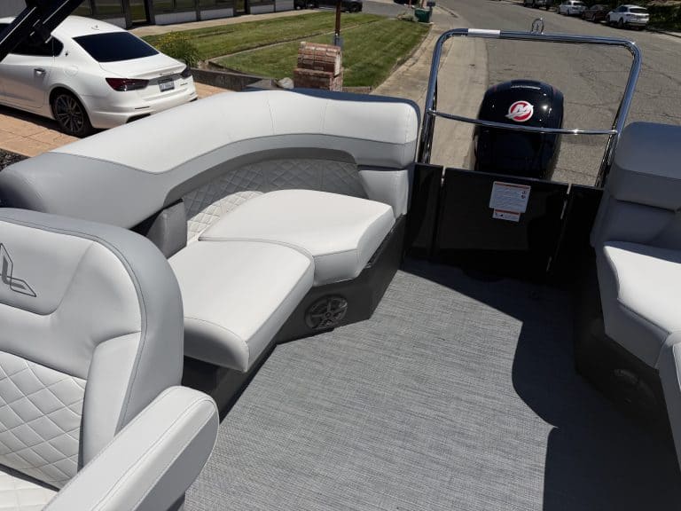 Recreational boat seating with comfortable white cushions and outboard motor, ideal for leisure and.