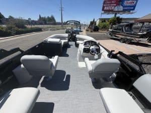 Boat interior with modern seating and steering console for optimal marine experience.
