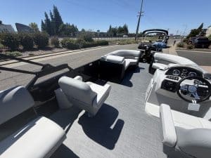 Pontoon boat interior with spacious seating and modern controls for optimal boating experience.