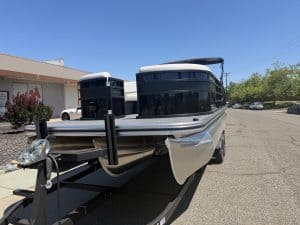 Pontoon boat with sleek black and silver design, ideal for leisure and water adventures.