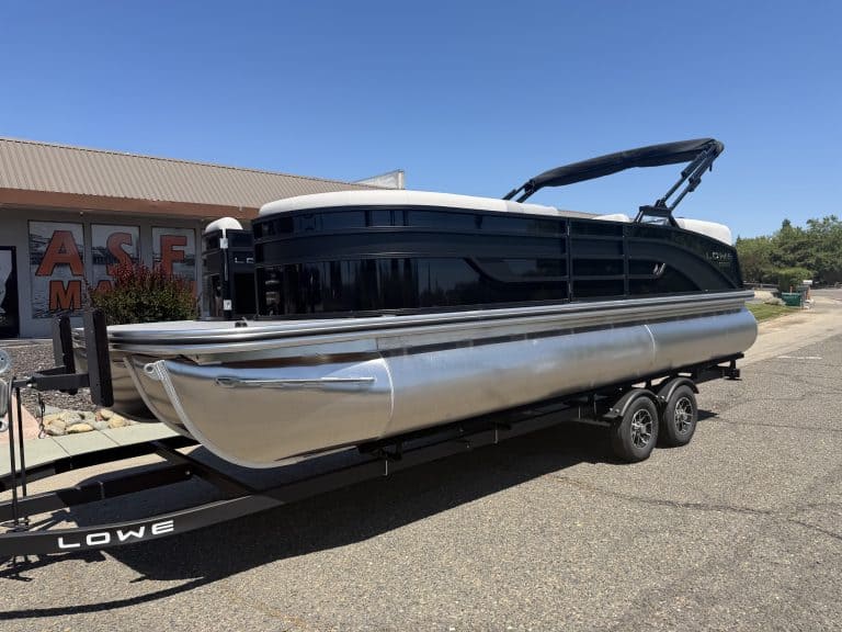 Luxury pontoon boat on trailer at ASFB Marine dealership.