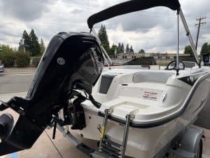 Boat with Mercury outboard engine on trailer, ready for water adventure.
