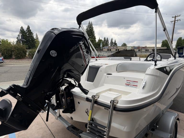 Boat with Mercury outboard engine on trailer, ready for water adventure.
