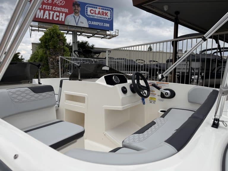 Boat cockpit with steering wheel and seating, outdoor marine vessel for leisure.