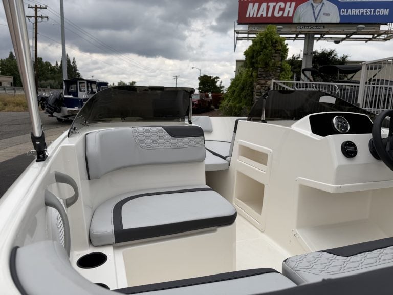 Boat interior with modern seating and dashboard for marine navigation.