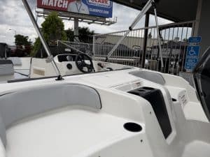 Boat dashboard with steering wheel and navigation controls for optimal marine experience.