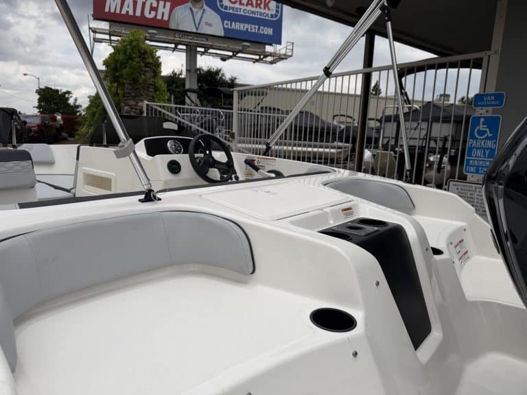 Boat dashboard with steering wheel and navigation controls for optimal marine experience.