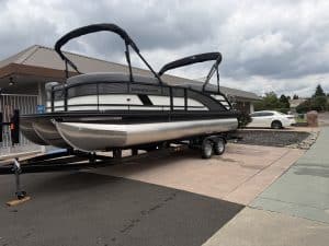 Pontoon boat on trailer at ASFB Marine dealership.