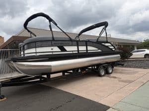 Modern pontoon boat on trailer at ASFB Marine, perfect for leisure and water adventures.
