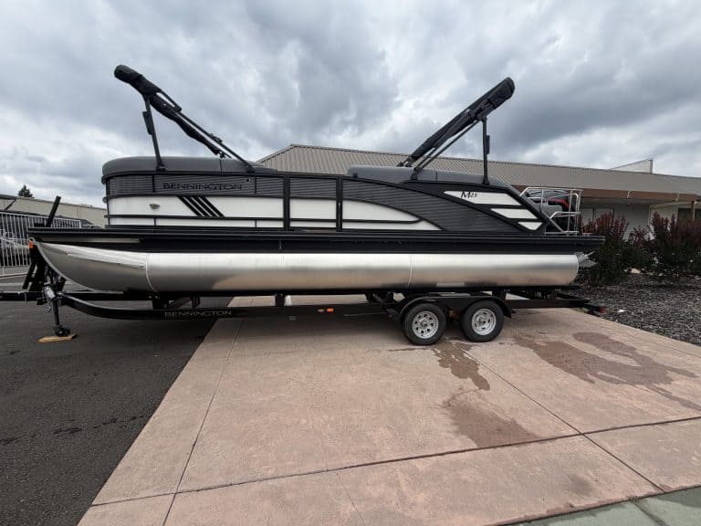 Sun Tracker pontoon boat on trailer, perfect for family boating adventures.