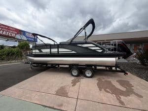 Pontoon boat with powerful outboard motor and spacious deck.