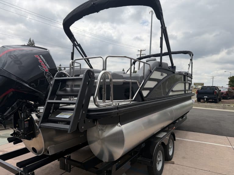 Pontoon boat with outboard motor on trailer, ready for water adventures. Perfect for leisure and fam.