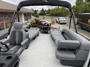 Spacious boat deck with comfortable seating and outboard motor for leisure cruising.