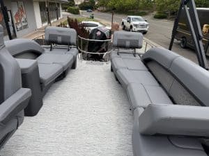 Comfortable pontoon boat seating with gray cushions and ample space for relaxation.