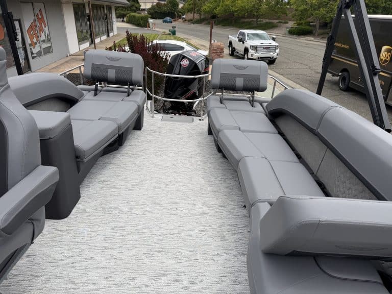 Comfortable pontoon boat seating with gray cushions and ample space for relaxation.