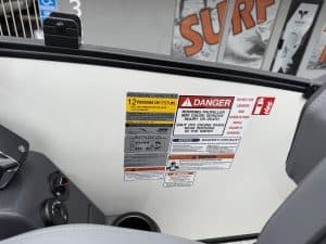 Warning labels for boat capacity, danger, and safety instructions.