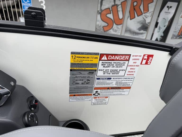 Warning labels for boat capacity, danger, and safety instructions.