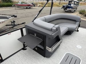 Luxury boat lounge seating with built-in storage and fold-out table for comfort and convenience.