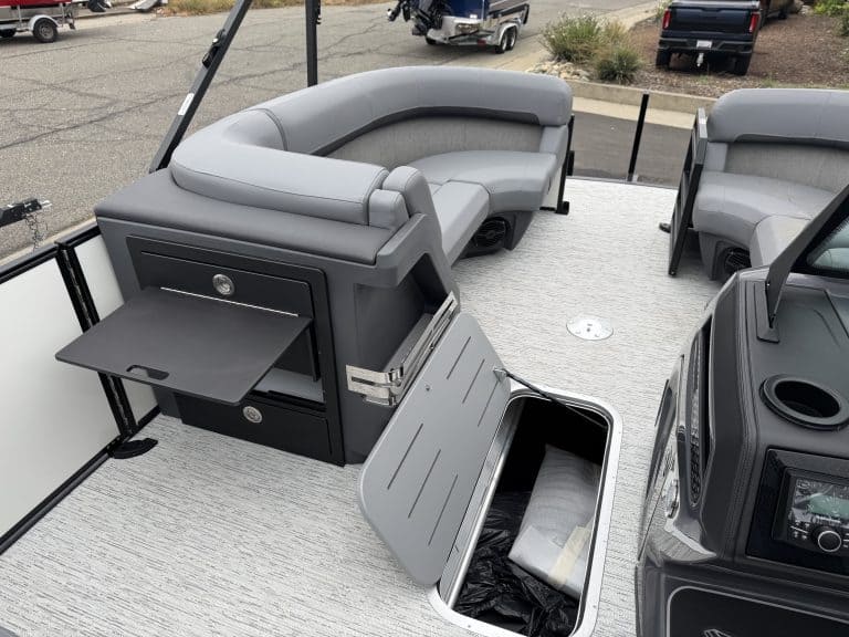 Luxury pontoon boat seating with storage compartment for marine accessories.