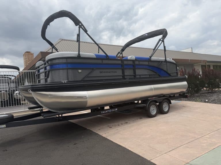 Pontoon boat with canopy on trailer, ready for water adventures. Perfect for leisure and family outi.