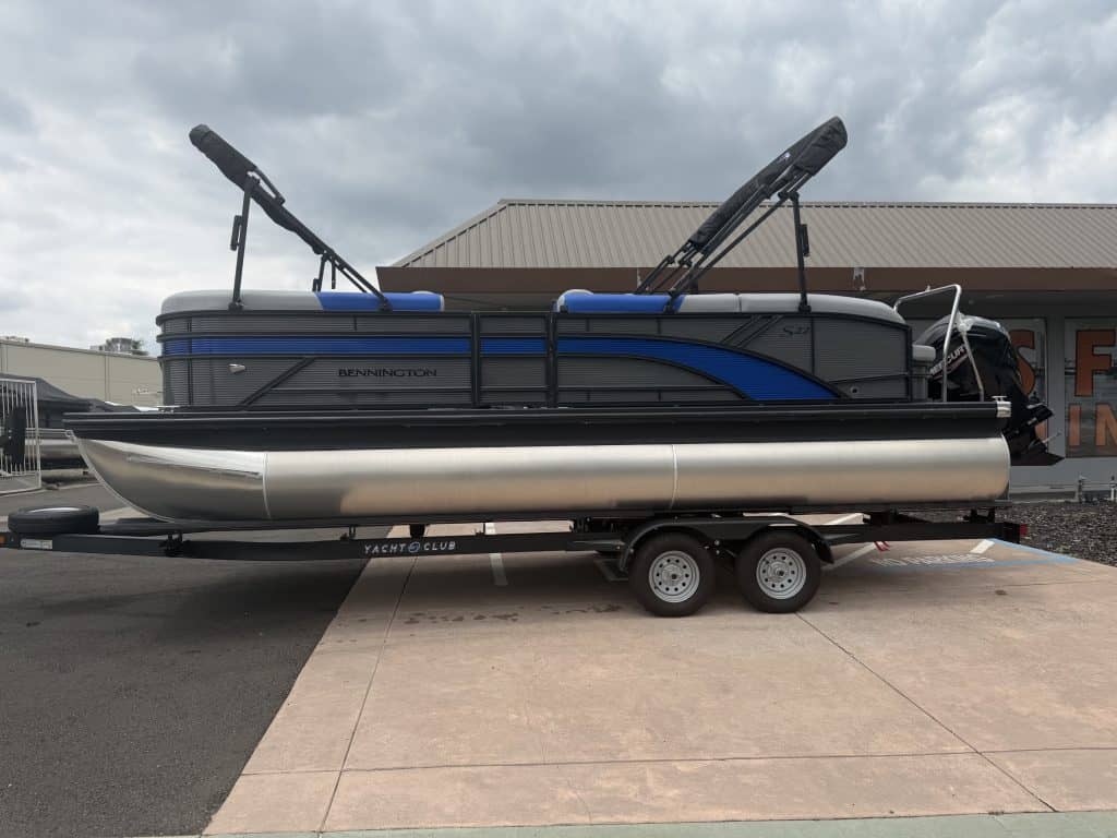 Modern Renegade Marine pontoon boat with wakeboard towers on trailer.