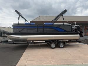 Modern Renegade Marine pontoon boat with wakeboard towers on trailer.