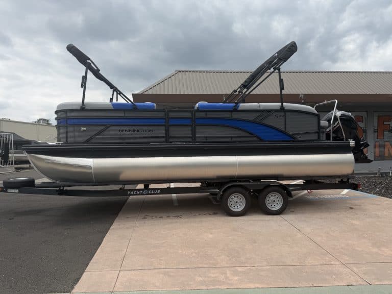 Modern Renegade Marine pontoon boat with wakeboard towers on trailer.
