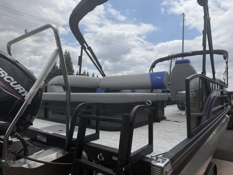 Marine boat with safety railings, seating, and outboard motor for water adventures.