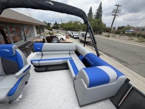 Boat lounge seating with custom cushions on a pontoon boat for relaxing on the water.
