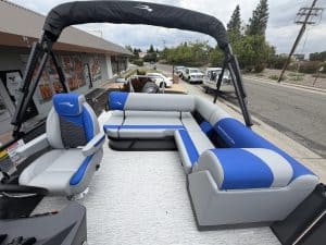 Recreational boat interior with comfortable seating and steering console for water adventures.