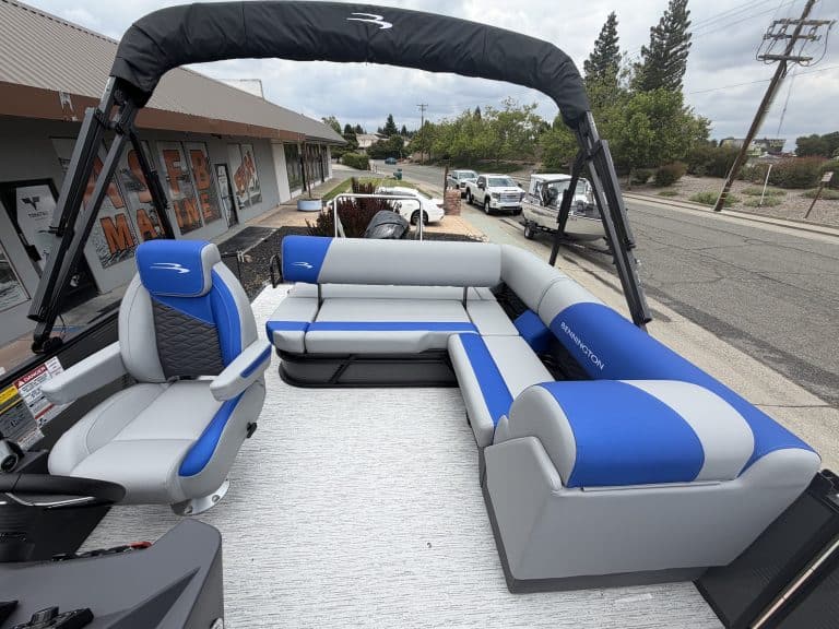 Recreational boat interior with comfortable seating and steering console for water adventures.