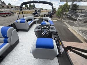 Modern luxury pontoon boat with blue and white seating, ideal for leisure and water adventures.