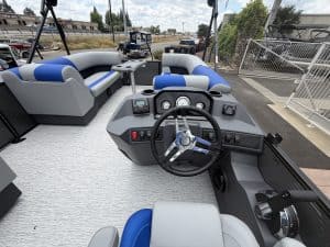 Pontoon boat dashboard with steering wheel and control panel for smooth navigation.