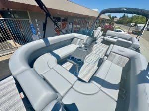 Luxury pontoon boat with seating and canopy for outdoor leisure.