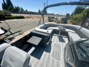 Modern boat interior with seating and steering wheel for marine adventures.