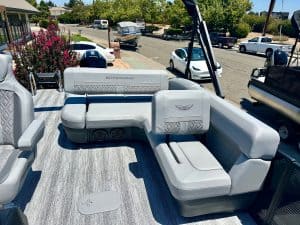 Luxury boat seating area with white cushions and a view of the marina.