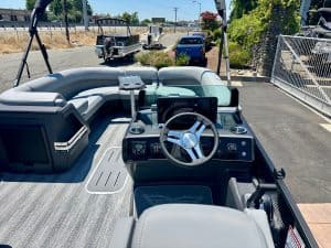 Modern boat interior with steering wheel and navigation system for sale.