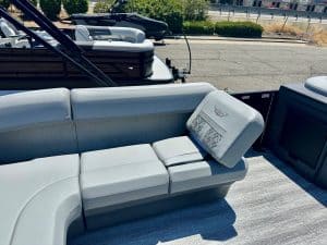 Modern boat seating with white cushions and a backrest with logo.