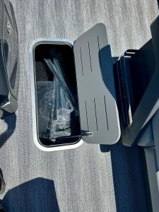 Marine trash bin with lid open on boat deck for waste disposal.