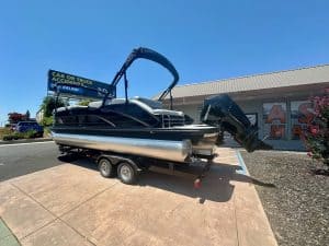 Newly renovated boat with outboard motor on trailer at ASFB Marine.