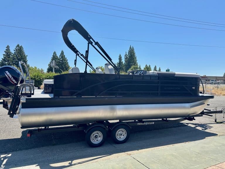 Pontoon boat with black canopy on trailer, ideal for water recreation and fishing. Perfect for boat.